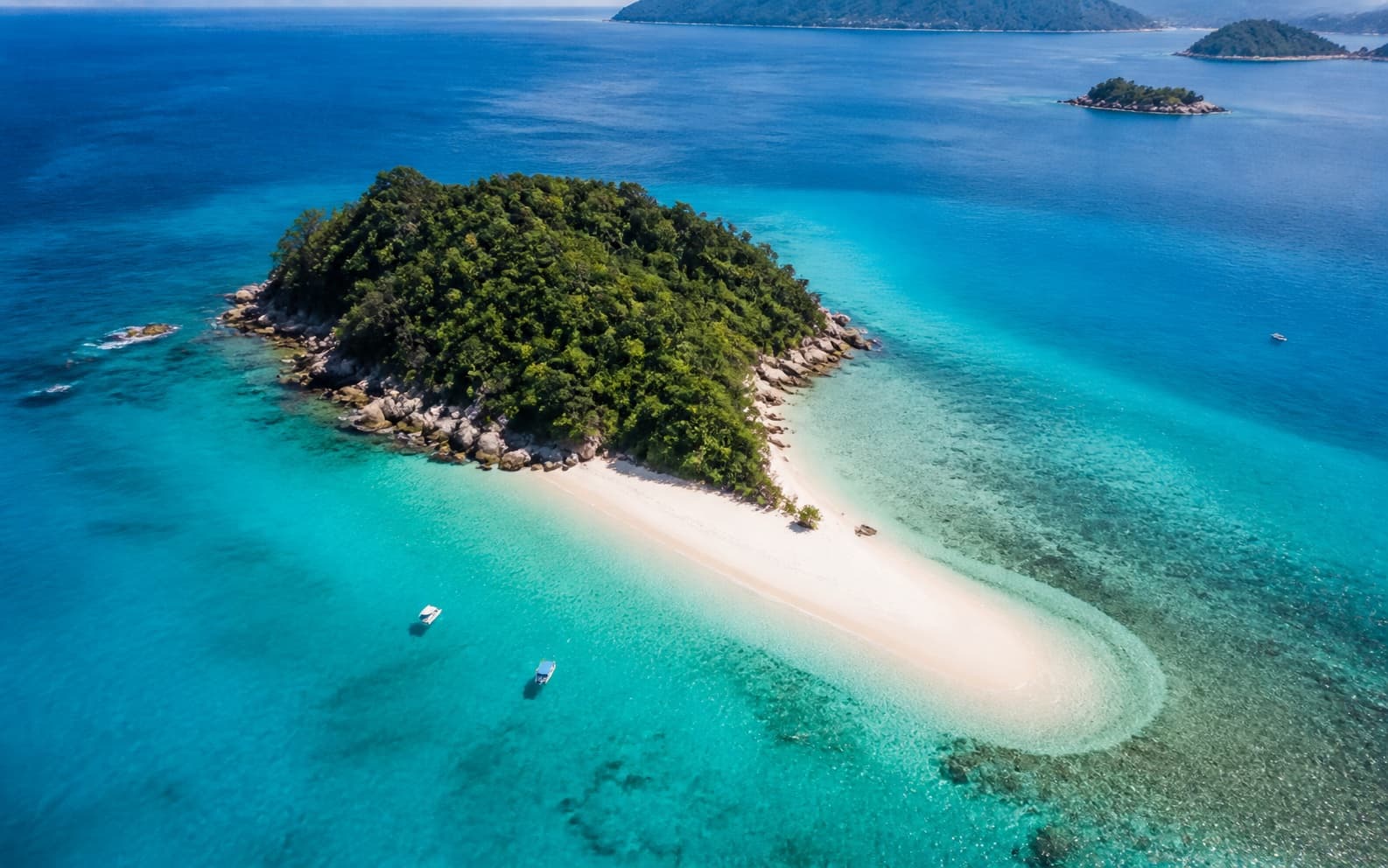 A tropical Malaysian island surrounded by clear turquoise water